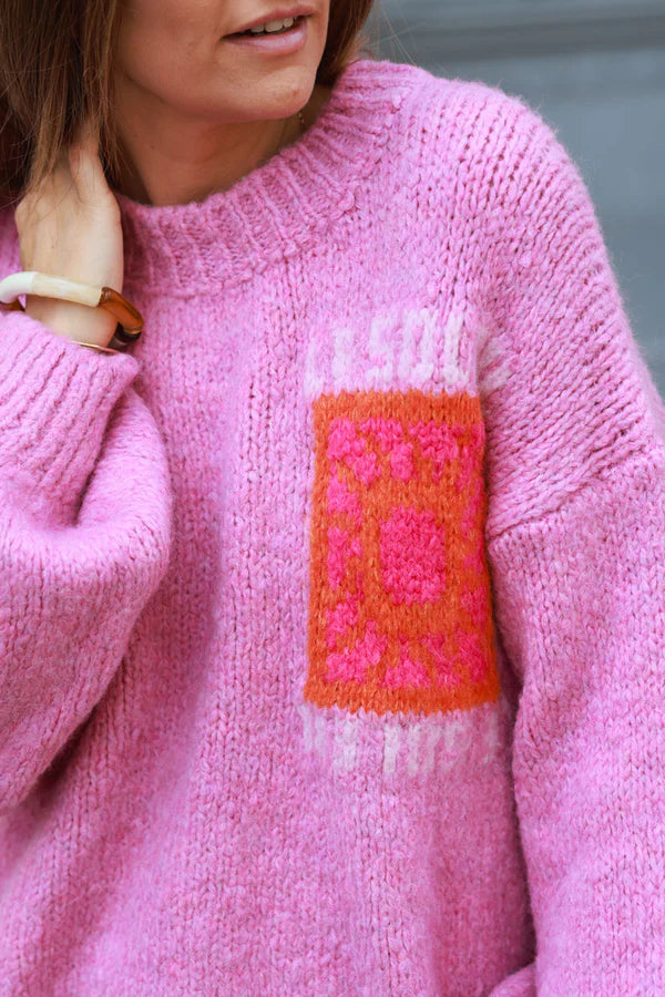 Pink chunky knit sweater with vibrant sun embroidery
