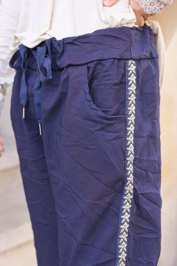 Navy blue stretch trousers with embroidered glitter star detail edging