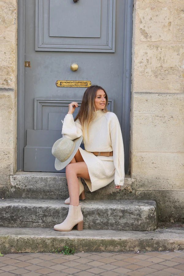 Off white ribbed sweater dress with funnel neck and button cuffs