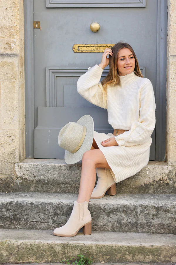 Off white ribbed sweater dress with funnel neck and button cuffs