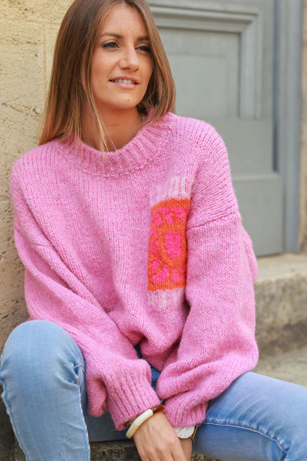 Pink chunky knit sweater with vibrant sun embroidery