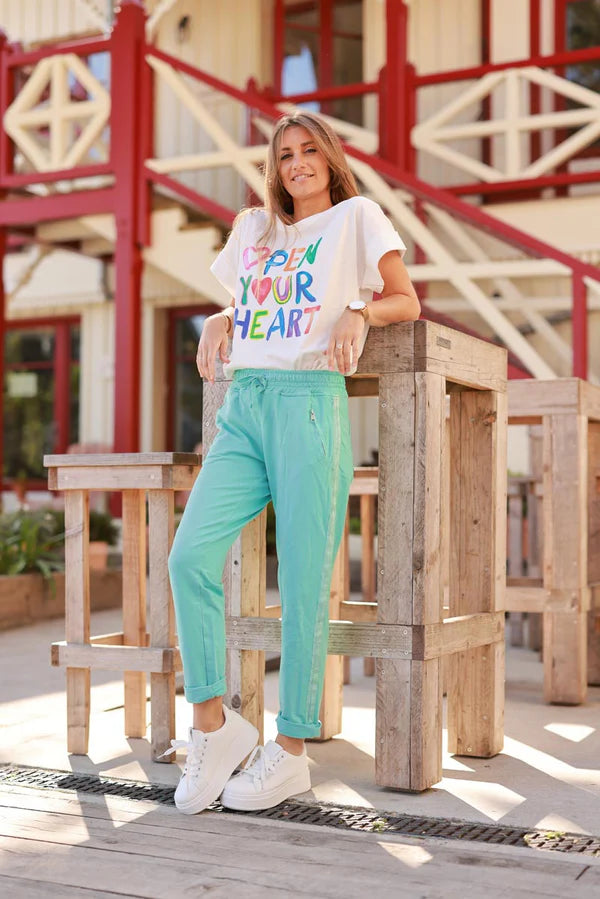Turquoise cotton jogging bottoms with embroidered cheveron outseams