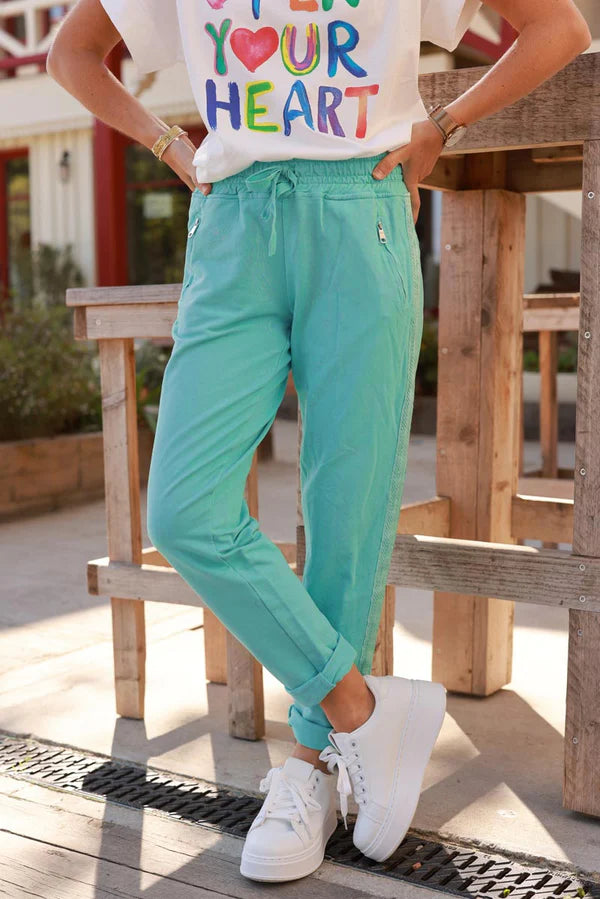Turquoise cotton jogging bottoms with embroidered cheveron outseams