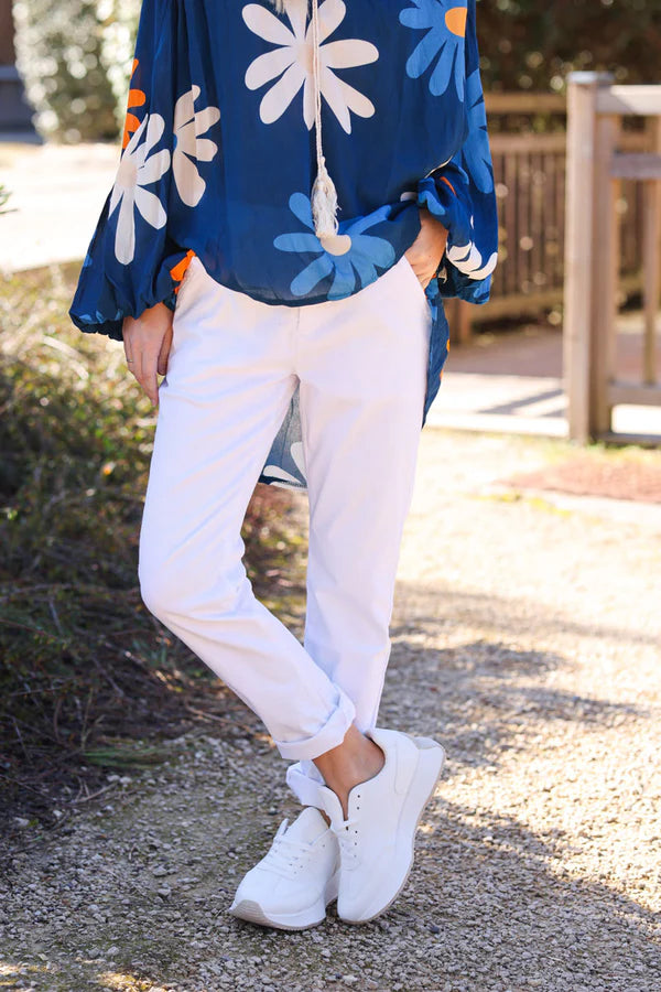 White stretch chino pants with tortoise shell buttons