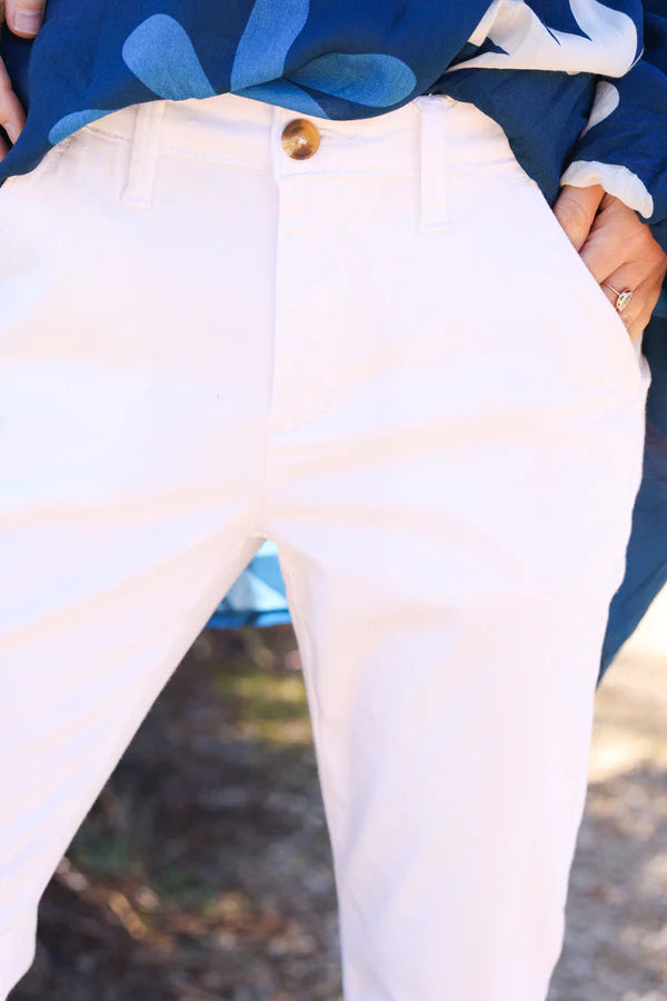 White stretch chino pants with tortoise shell buttons